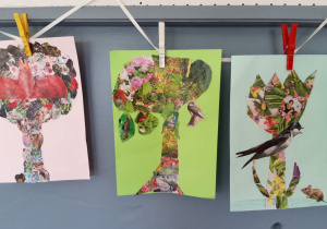 Na tasiemce wiszą trzy prace plastyczne przypięte spinaczami wykonane na kolorowym kartonie, przedstawiające dwa drzewa i krokusa zrobione techniką kolażu.