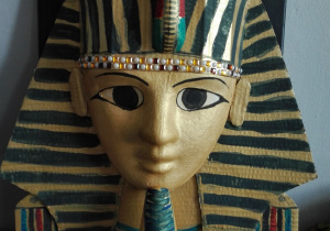 Maska grobowa faraona Tutanchamona wykonana z masy plastycznej, z wykorzystaniem ozdobnych materiałów papierniczych, z elementami ozdobnych kamyczków-Marcel Kamiński i Antoni Wawrzyniak, uczniowie klasy 5B.