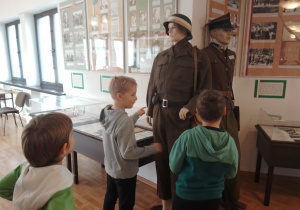 Zdjęcie przedstawia uczniów klasy 1a oglądających eksponaty znajdujące się w Muzeum Armii Krajowej Okręgu Wileńskiego
