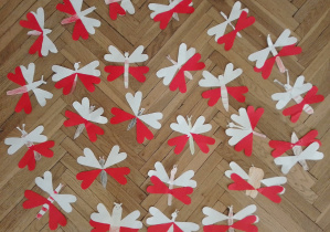 Motyle ze skrzydłami biało-czerwonymi, nawiązujące kolorystyką do barw narodowych Polski. Prace wykonane przez uczniów klas młodszych.